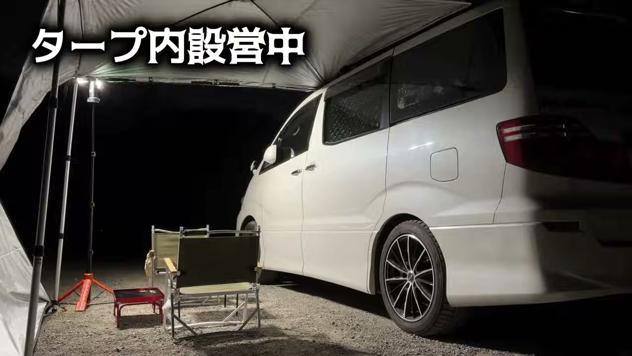 タープの下に椅子とテーブルを出したキャンプ場のサイト